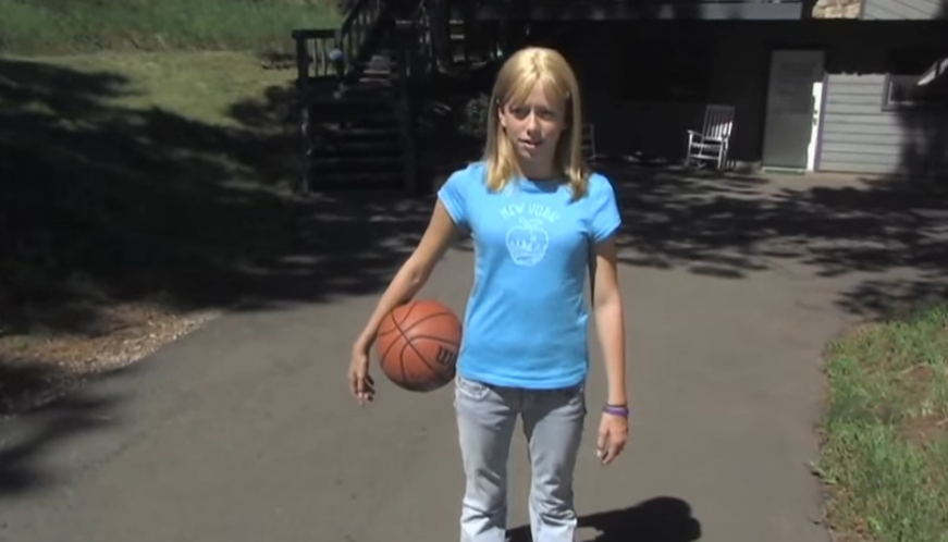 Girl with alopecia areata holding a basketball